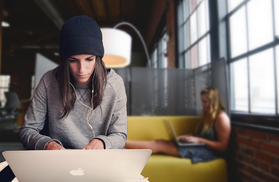 woman in beanie working on laptop